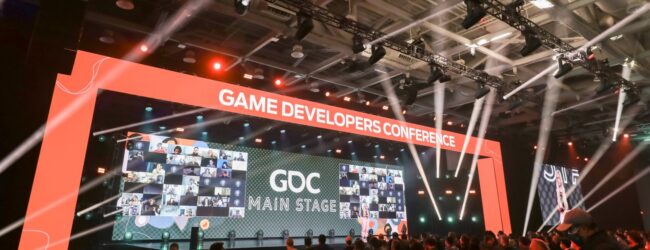 The GDC stage with lights and an audience